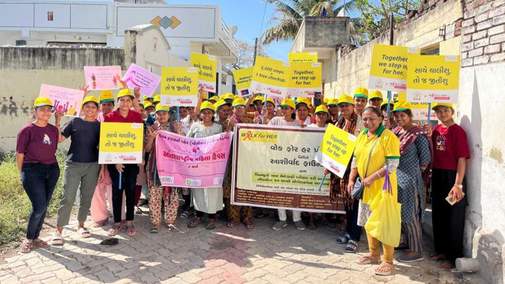 Women walking together through Lathi during the Walk for Her event